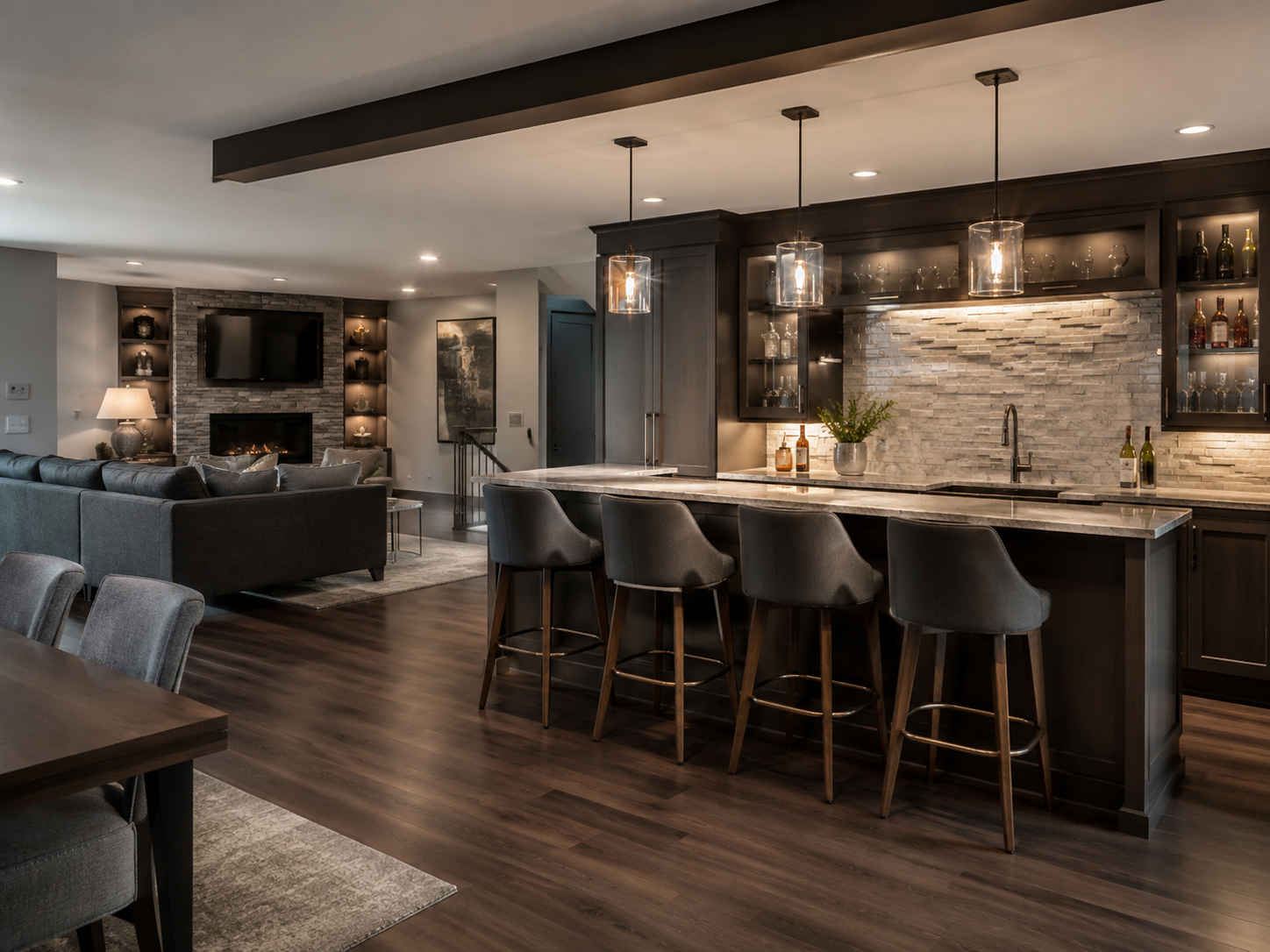 Finished basement with full wet bar, stone backsplash, pendant lighting, and lounge seating area